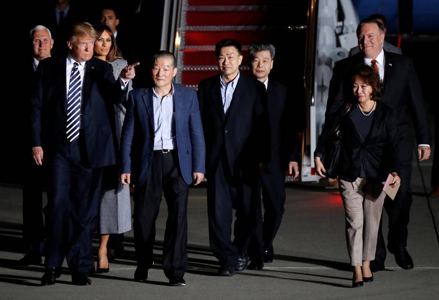 U.S.President Donald Trump gestures next to the three Americans released from detention in North Korea, Tony Kim, Kim Hak-song and Kim Dong-chul, upon their arrival at Joint Base Andrews