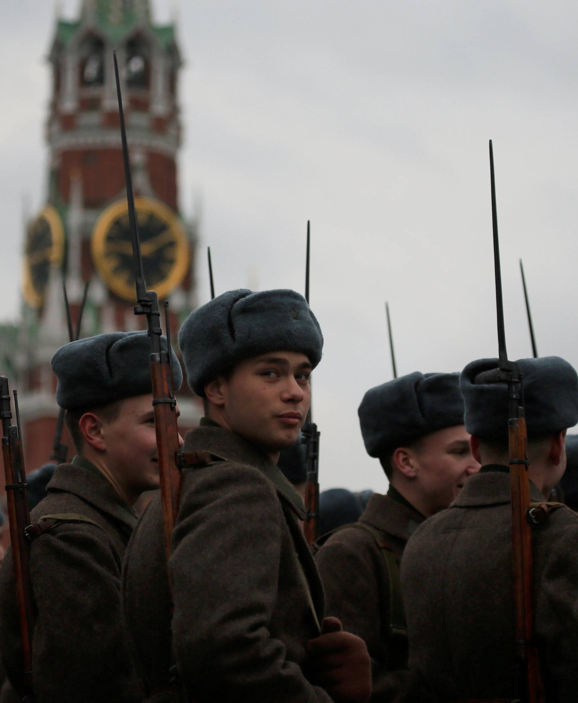 Russian servicemen dressed in historical uniforms wait before a military parade marking the anniversary of the 1941 parade, when Soviet soldiers marched towards the front lines of World War Two, at Red Square in Moscow