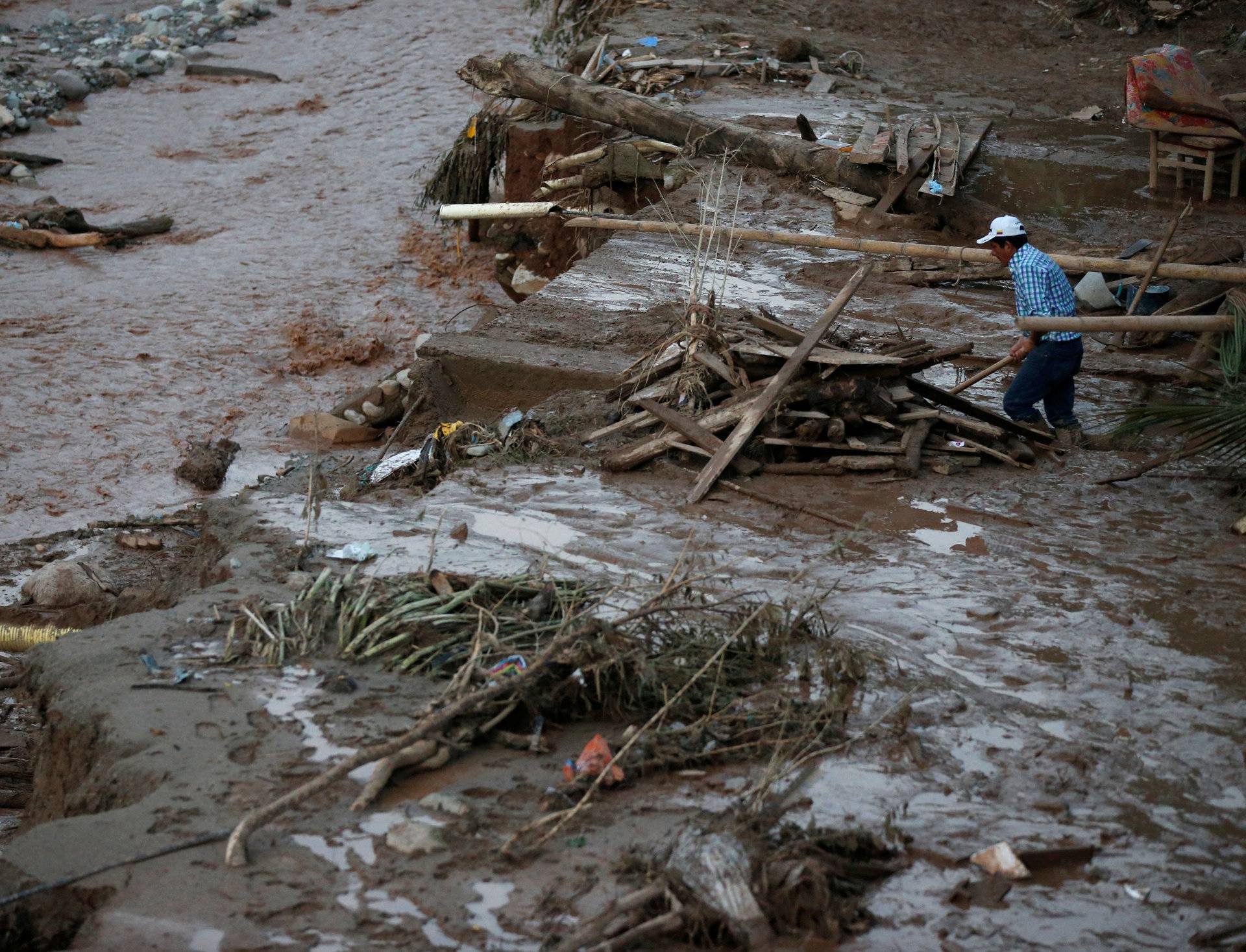 A man searches for his belongings after heavy rains caused several rivers to overflow, pushing sediment and rocks into buildings and roads in Mocoa, Colombia
