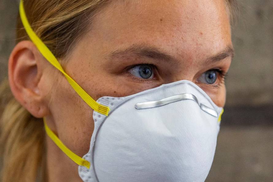 Israeli model Bar Refaeli wears a face mask as she arrives for a hearing in the tax evasion case against her and her mother Tzipi, at a court in Tel Aviv, Israel