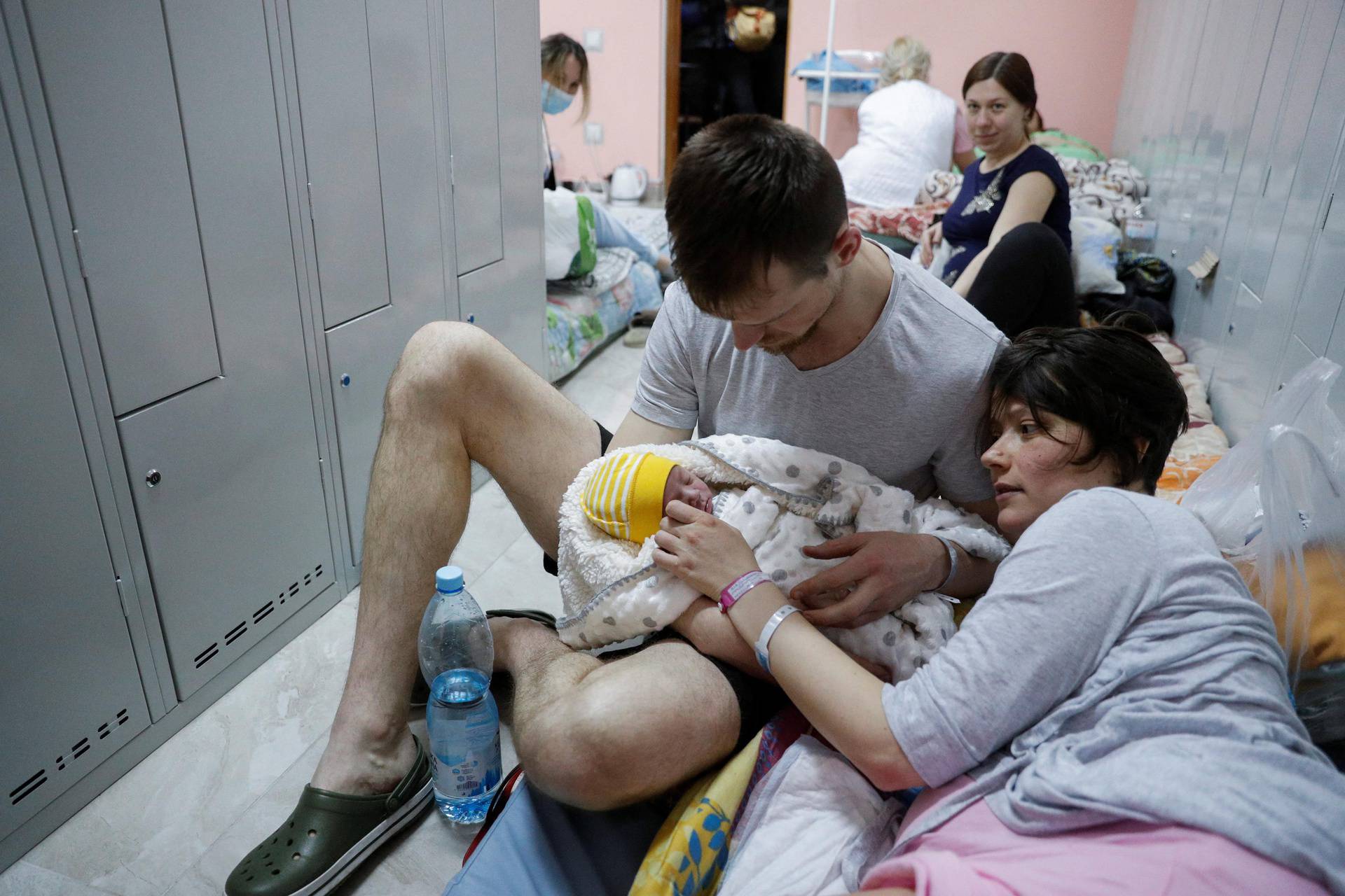 A couple with their newborn baby take shelter in the basement of a perinatal centre as air raid siren sounds are heard amid Russia's invasion of Ukraine, in Kyiv