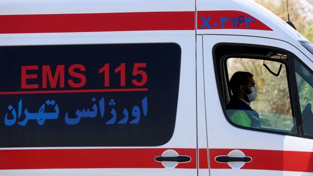 An emergency member sits inside an ambulance, amid the spread of the coronavirus disease (COVID-19), in Tehran