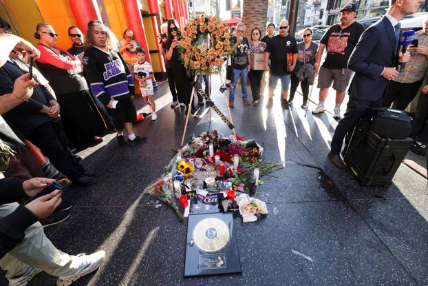 Flowers and pictures are placed on the star of late Ozzy Osbourne at the Hollywood Walk of Fame in Los Angeles