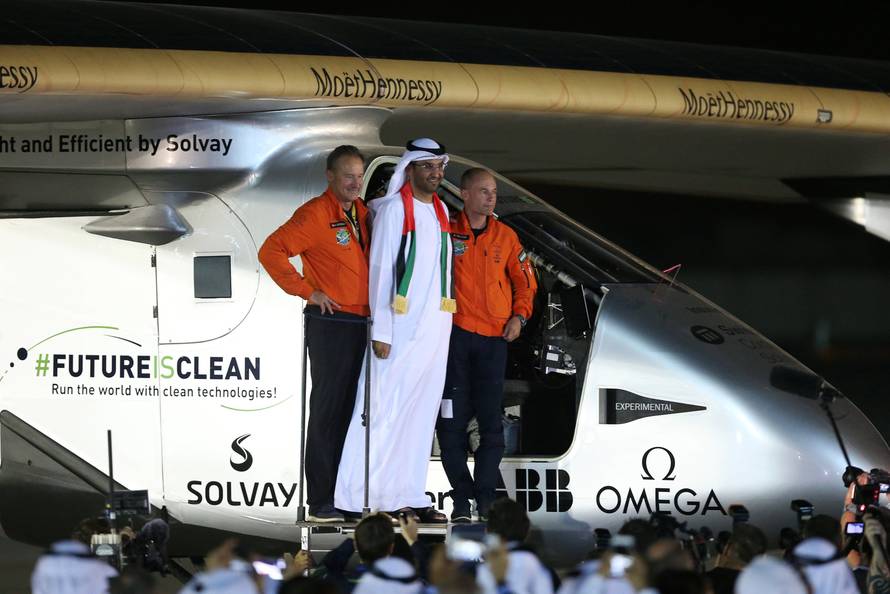 Pilot Andre Borschberg and Bertrand Piccard pose with Sultan Ahmed al-Jaber following the arrival of Solar Impulse 2, a solar powered plane, at an airport in Abu Dhabi