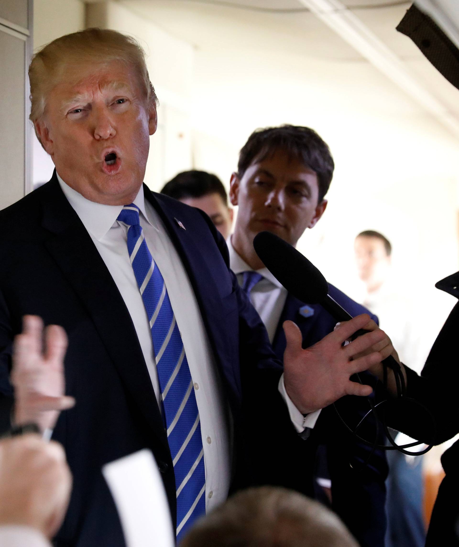 U.S. President Donald Trump speaks aboard Air Force One