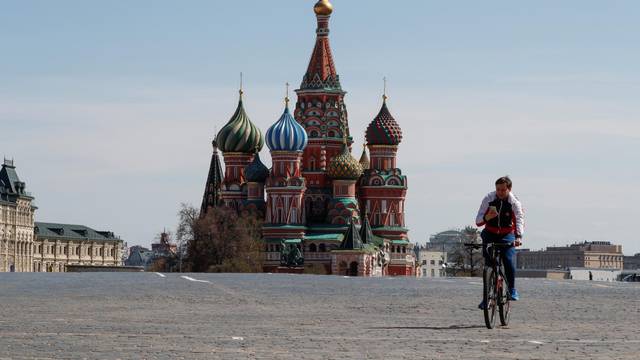 A man rides a bicycle along empty Red Square amid the coronavirus disease outbreak in Moscow