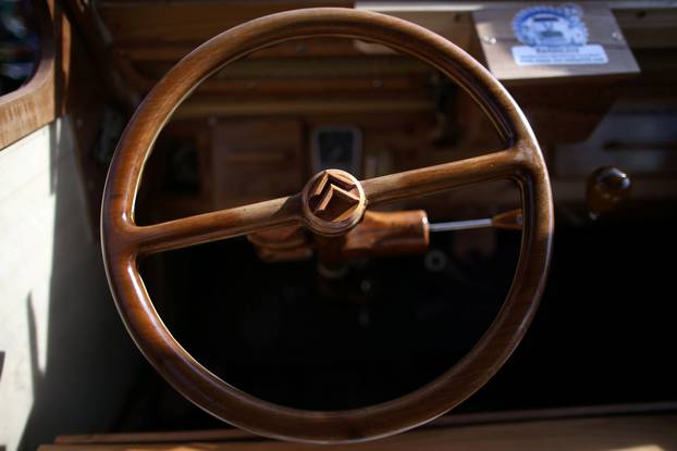 The wheel is seen in the hand-built 2CV Citroen car made out of fruitwood by Michel Robillard, a french cabinet maker, in Loches