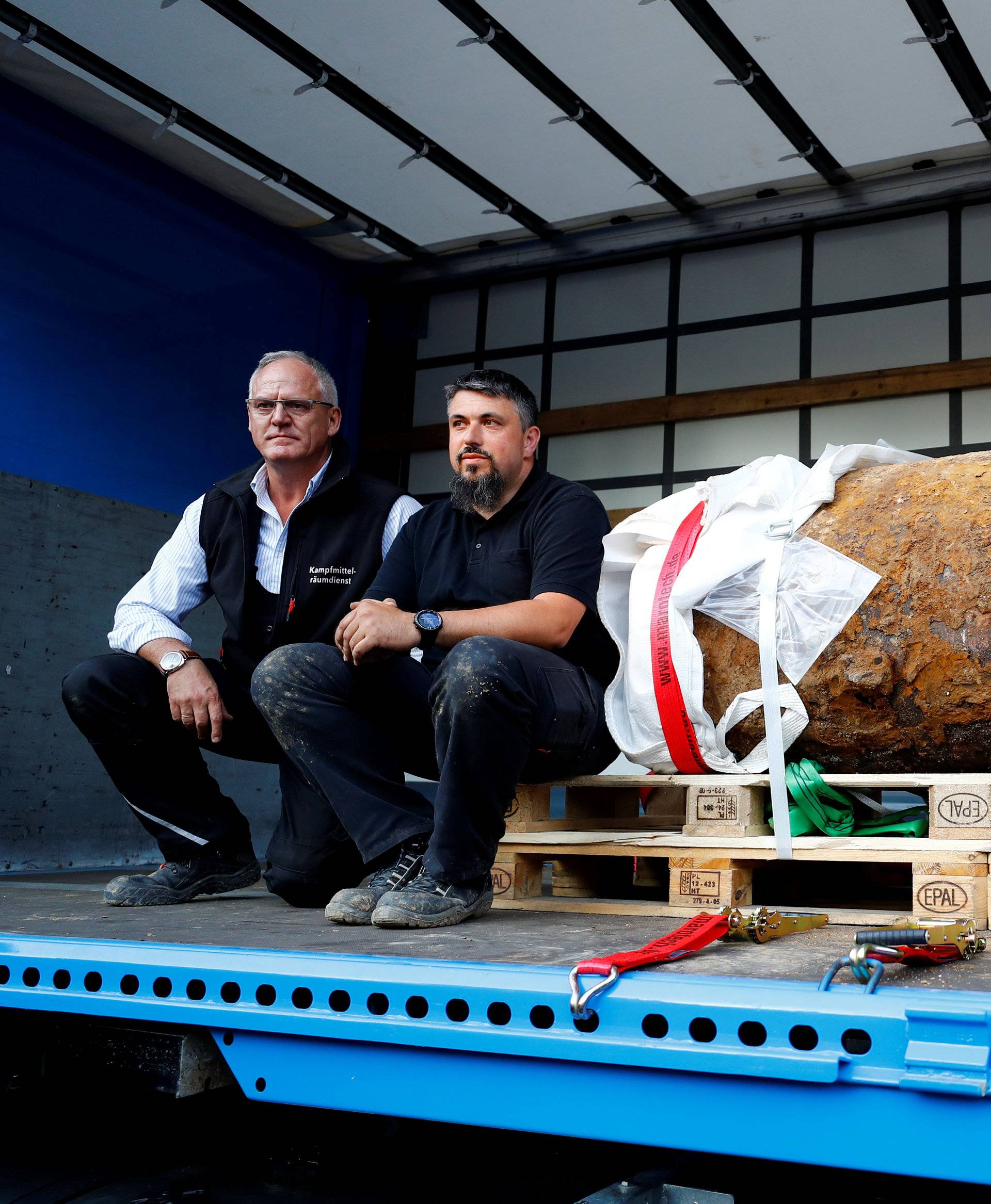 Bomb disposal expert Rene Bennert and Dieter Schweizler speak next to defused massive World War Two bomb after tens of thousands of people evacuated their homes in Frankfurt