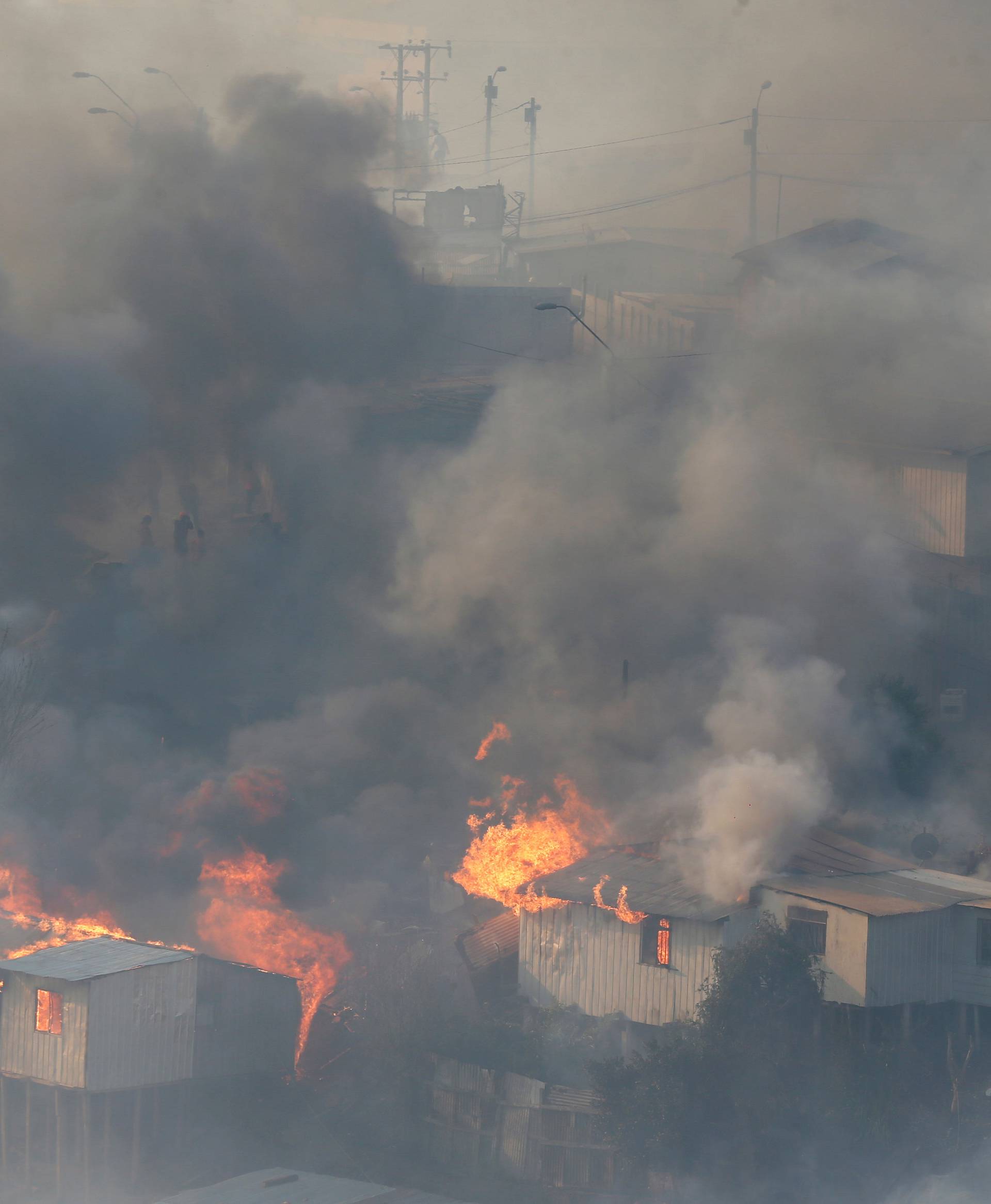 Fire burns houses on a hill, where more than 100 homes were burned due to a forest fire but there have been no reports of death, local authorities said in Valparaiso, Chile