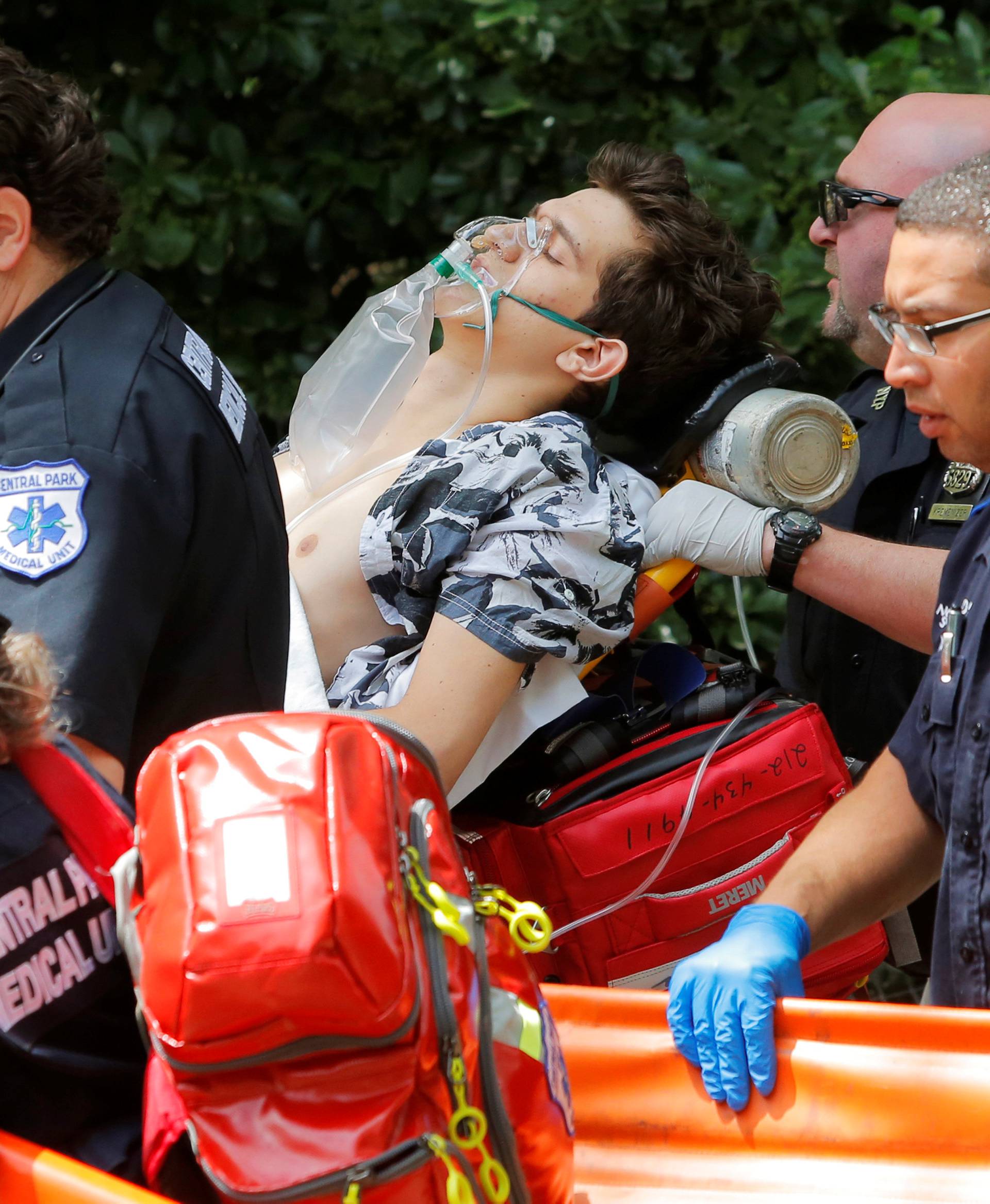 Medics remove a man who was injured after an explosion in Central Park in Manhattan, New York, U.S.
