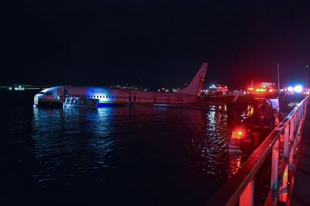 Boeing 737 aircraft sits in shallow water of the St Johns River after it slid off the runway at Naval Air Station Jacksonville, Florida