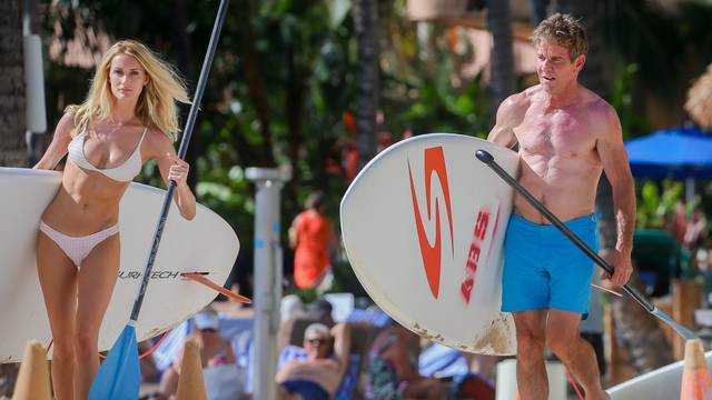 *EXCLUSIVE* A shirtless Dennis Quaid 65, shows off his ripped body while enjoying a beach day with 26 year old girlfriend, Laura Savoie in Hawaii! - ** WEB MUST CALL FOR PRICING **