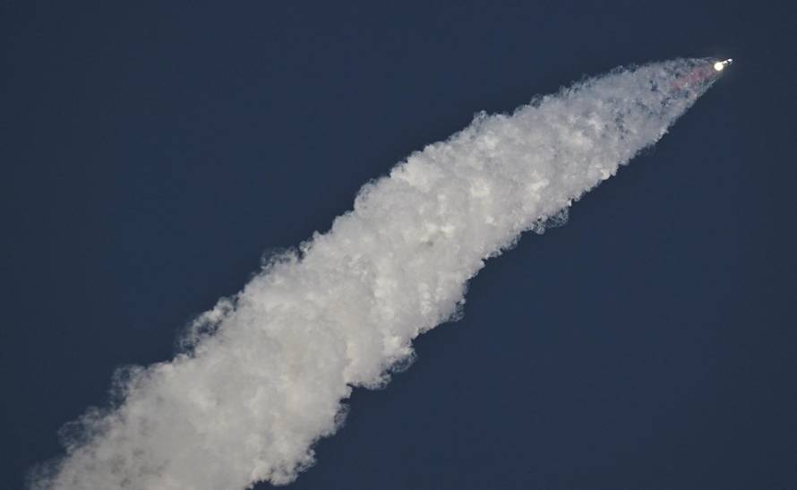 A SpaceX Super Heavy booster carrying the Starship spacecraft lifts off on its 10th test flight