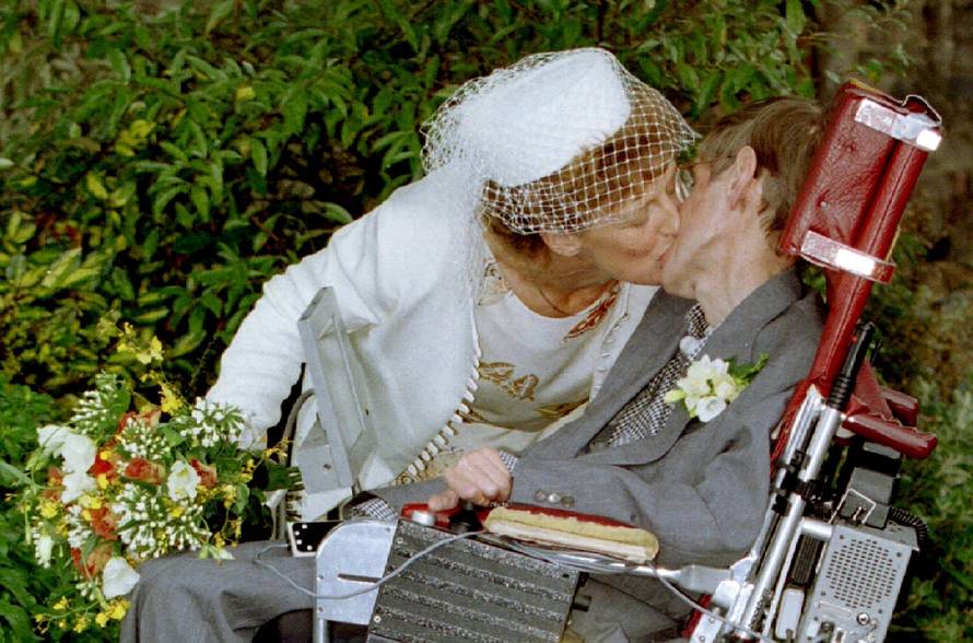 A kiss for scientist and theorist Stephen Hawking from his new bride Elaine Mason after their civil ..