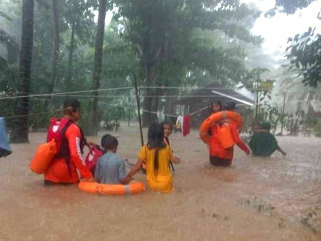 Rescue workers help people affected by floods in Philippines