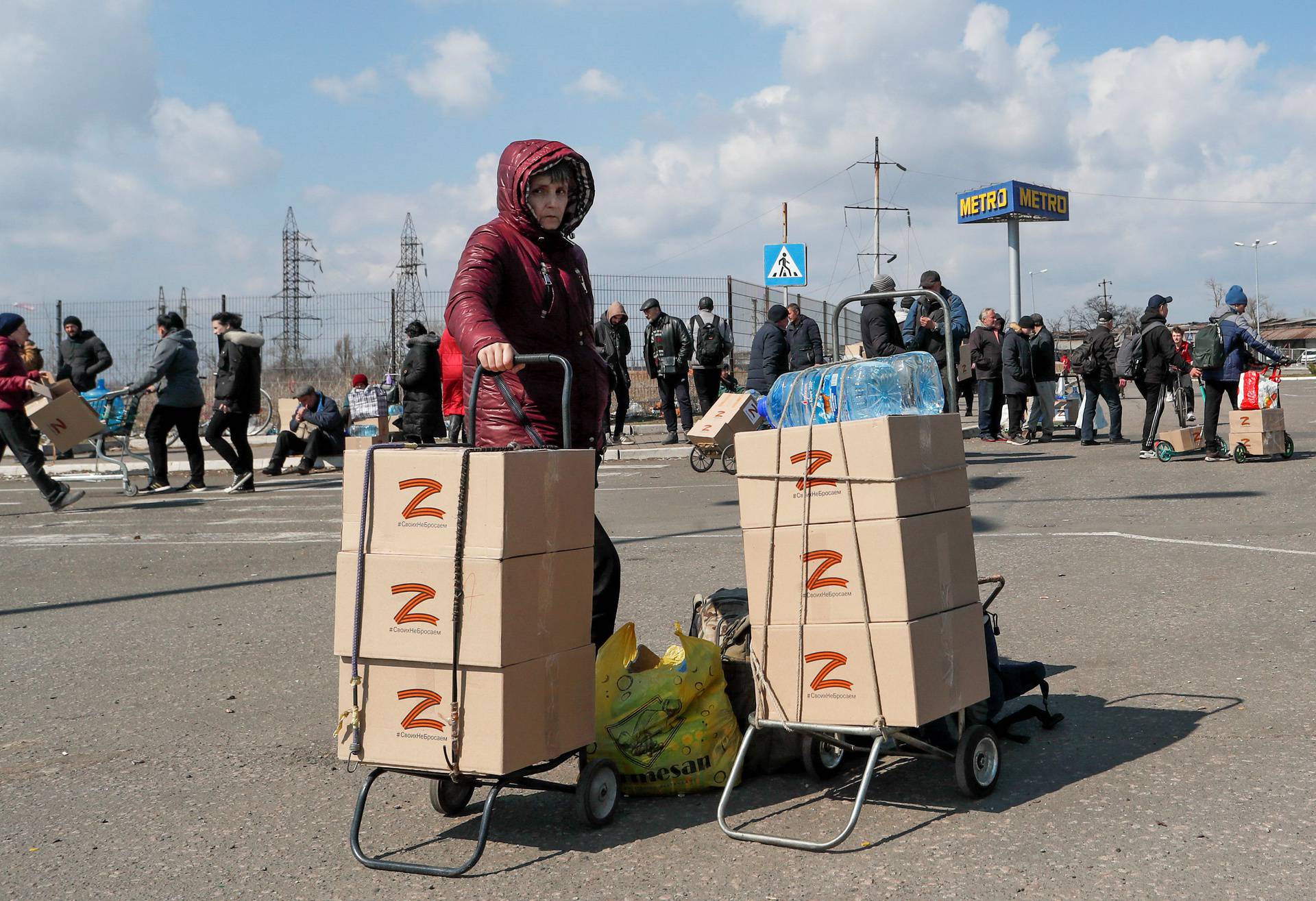 People receive humanitarian aid in Mariupol