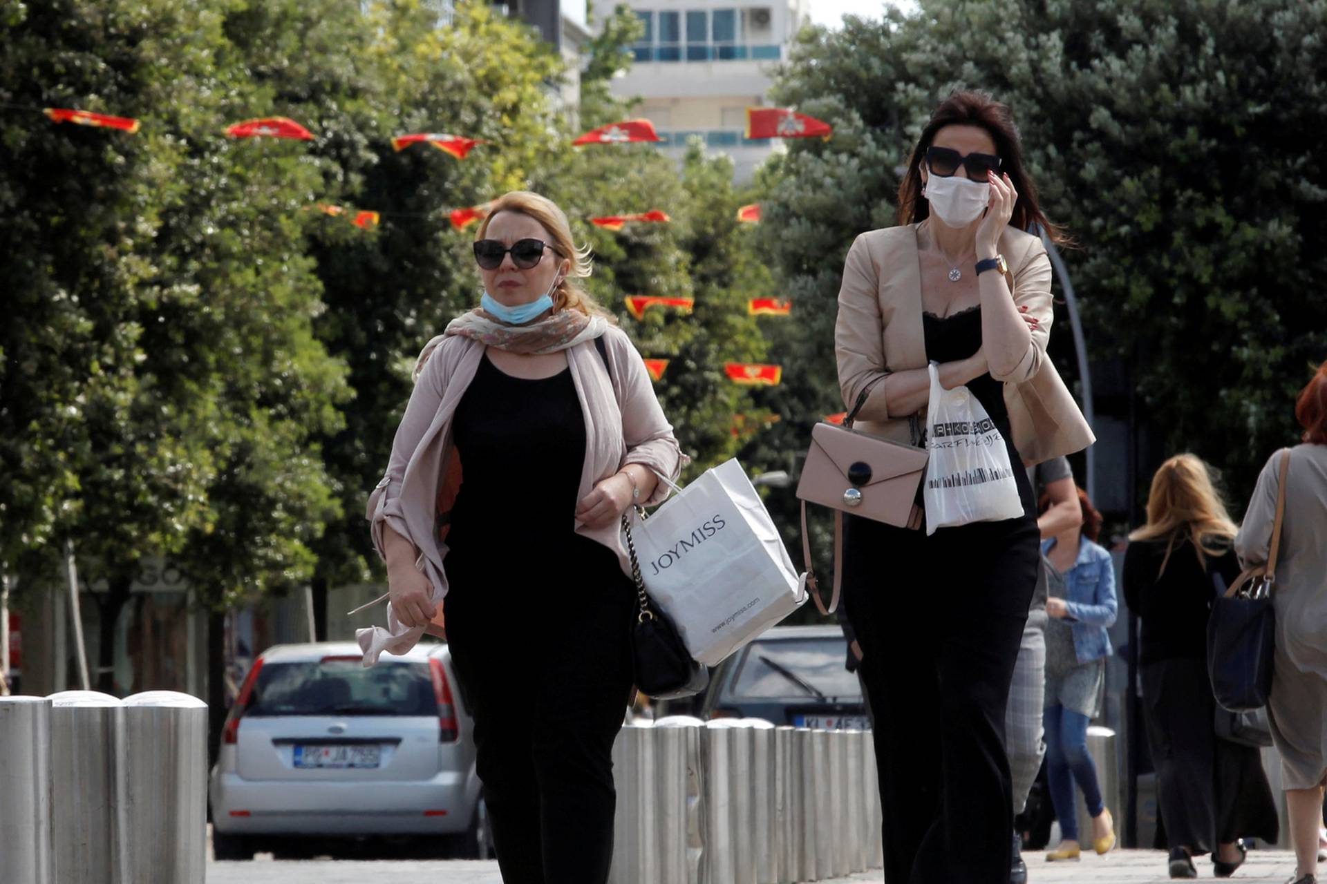 FILE PHOTO: Women wearing masks walk on a street after Prime Minister Dusko Markovic declared the country the coronavirus disease (COVID-19)-free in Podgorica