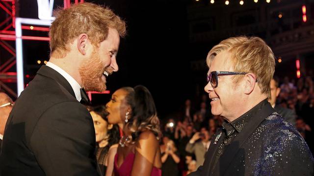 FILE PHOTO: Britain's Prince Harry greets Elton John after the Royal Variety Performance at the Albert Hall in London