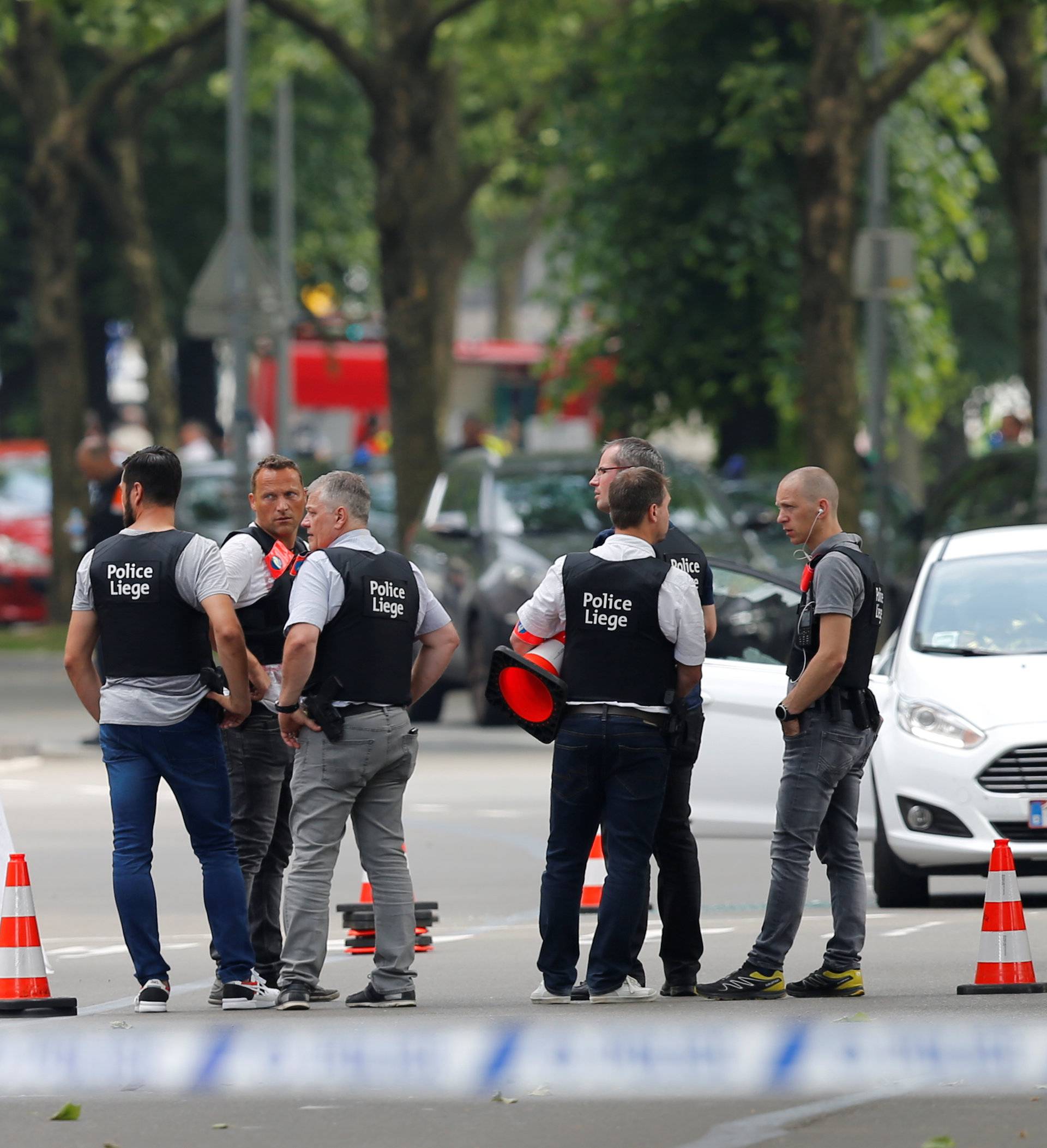 Police officers are seen on the scene of a shooting in Liege