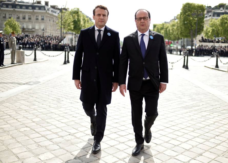 Outgoing French President Hollande and President-elect Macron attend a ceremony to mark the end of World War II at the Tomb of the Unknown Soldier at the Arc de Triomphe in Paris
