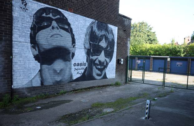 A view of a mural of Oasis band members Liam and Noel Gallagher by artist Pic.One.Art on the side of Sifters record shop in the Burnage area of Manchester