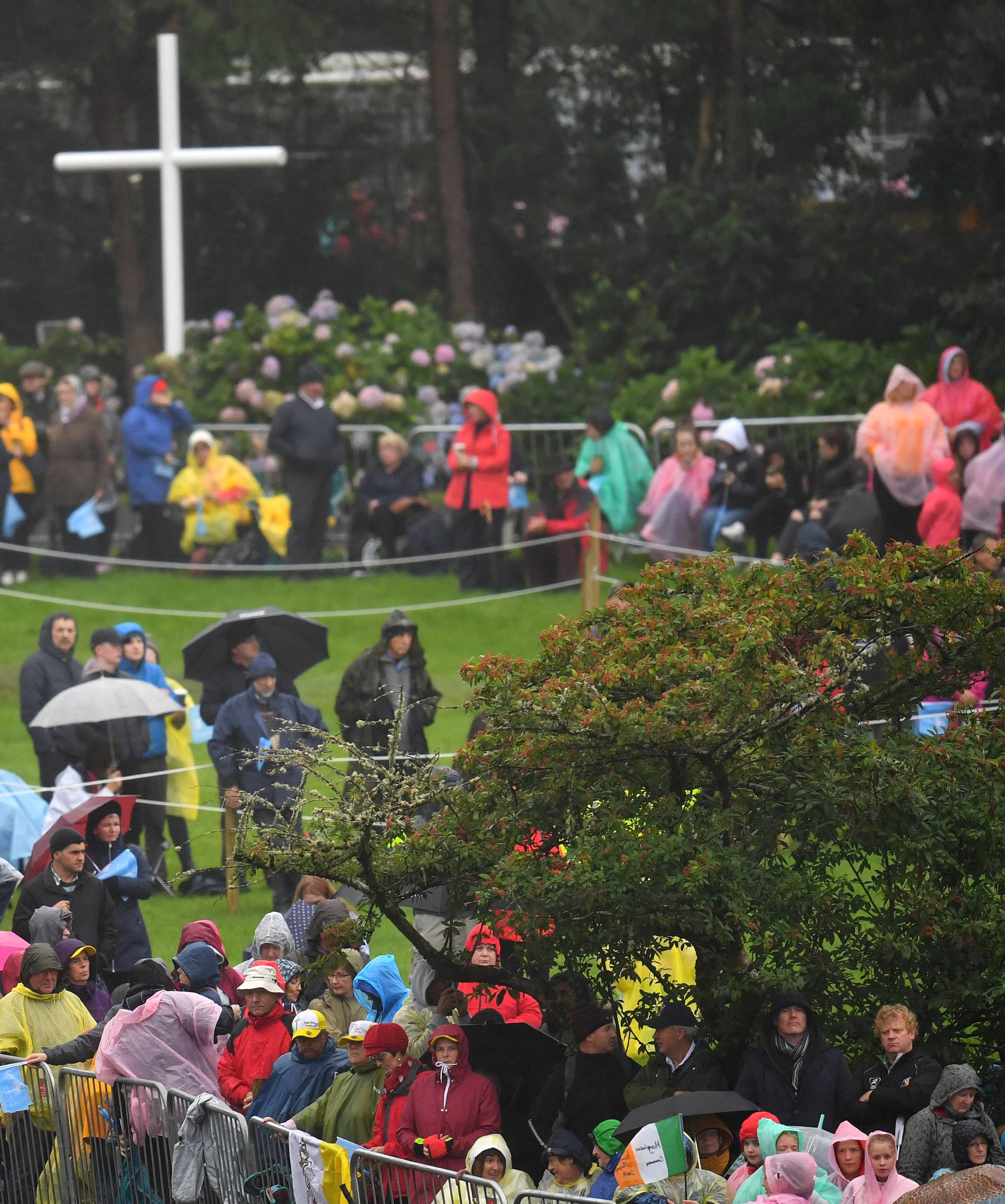 The faithful wait in the rain ahead of a visit of Pope Francis to Knock Shrine in Knock