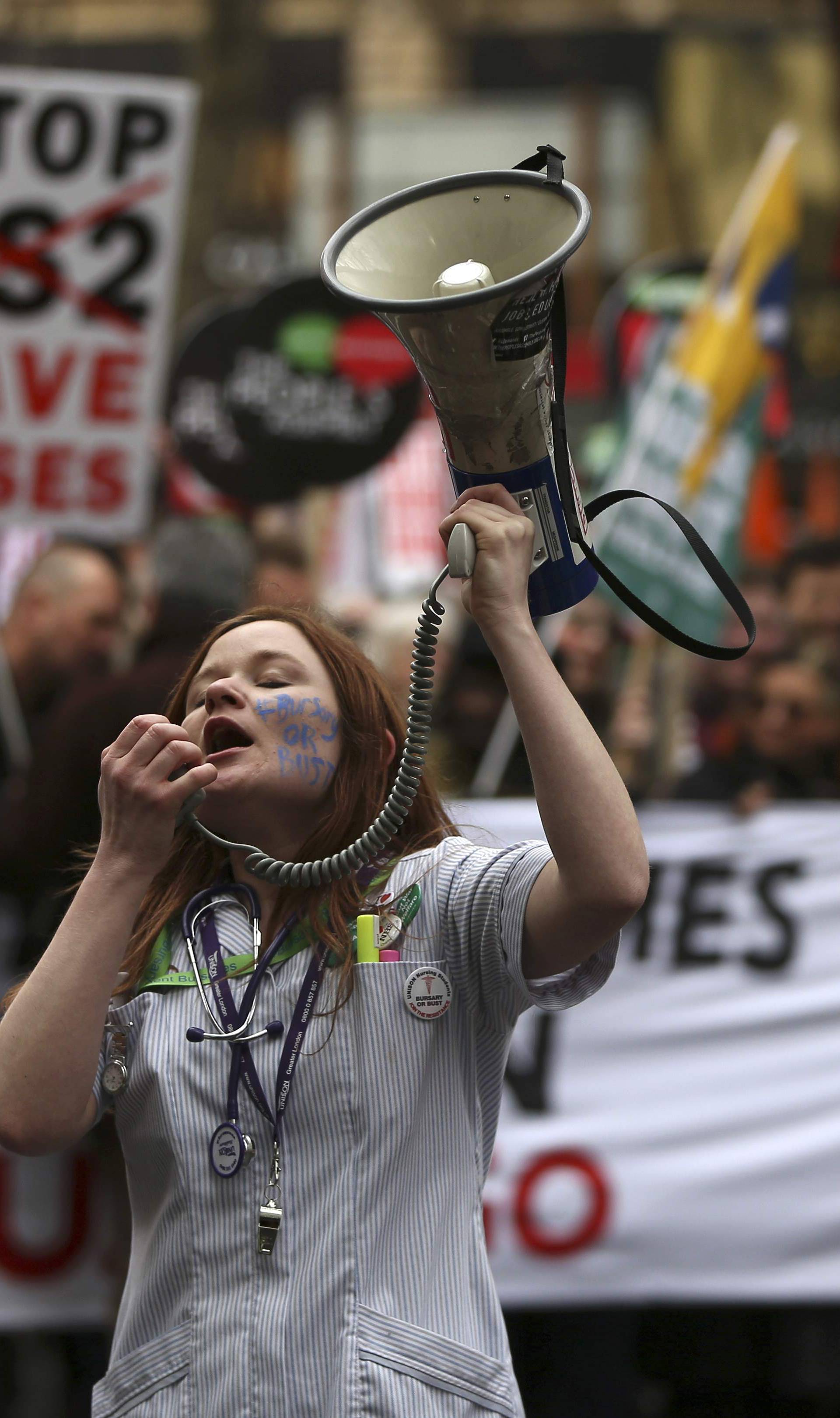 A demonstrator shouts through a megaphone during an anti-austerity protest in London