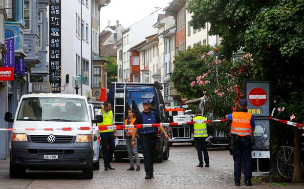 Swiss police officers stand at a crime scene in Schaffhausen