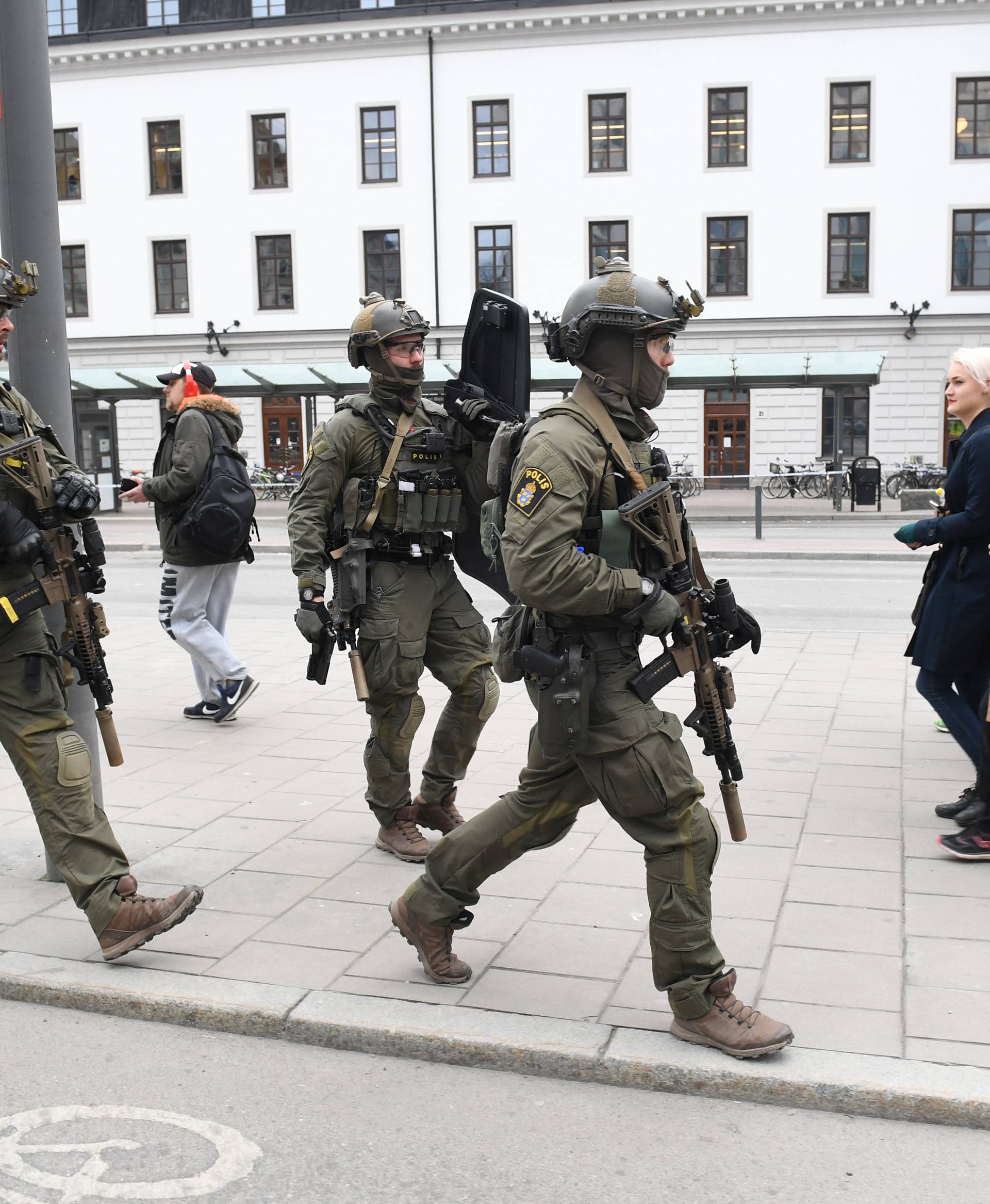 Police officers are seen outside Stockholm Central station after people were killed when a truck crashed into department store Ahlens, in central Stockholm