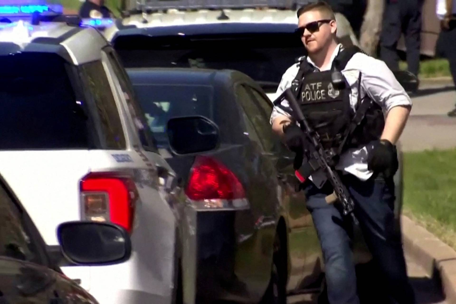 A law enforcement officer runs near the Covenant School after a shooting in Nashville