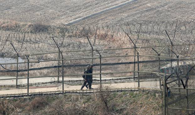 Paju, South Korea. 1st April 2014. South Korean soldiers patrol along the military fences near DMZ, Paju, South Korea, on Tuesday April 1, 2014. North and South Koreas exchanged artillery fire across the western maritime border, the Northern Limit Line (N