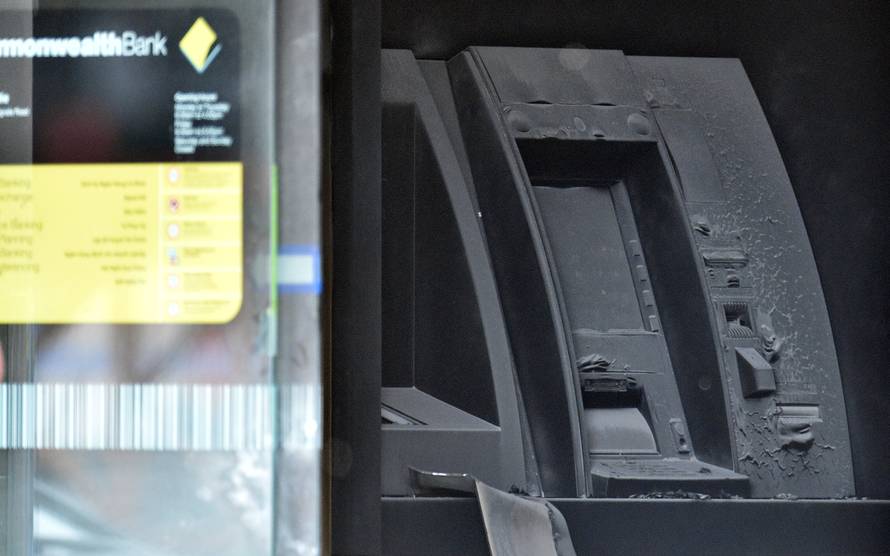 An electronic cash machine is burned at a branch of the Commonwealth Bank after a fire injured customers in Melbourne