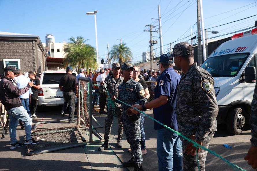 Police officers work at the site of the collapsed Jet Set nightclub in Santo Domingo