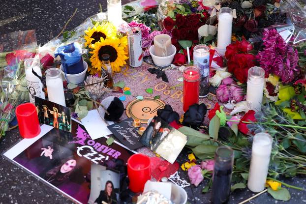 Flowers and pictures are placed on the star of late Ozzy Osbourne at the Hollywood Walk of Fame in Los Angeles