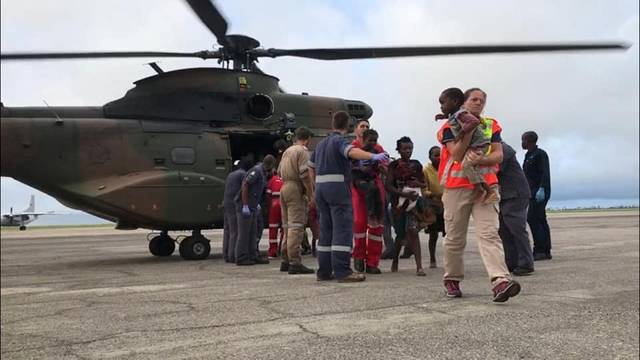 Rescue workers help affected residents after cyclone damage in Beira