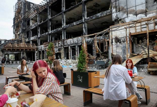 FILE PHOTO: People visit a McDonald's restaurant located in an area that was hit by ​​numerous missile attacks in Kyiv