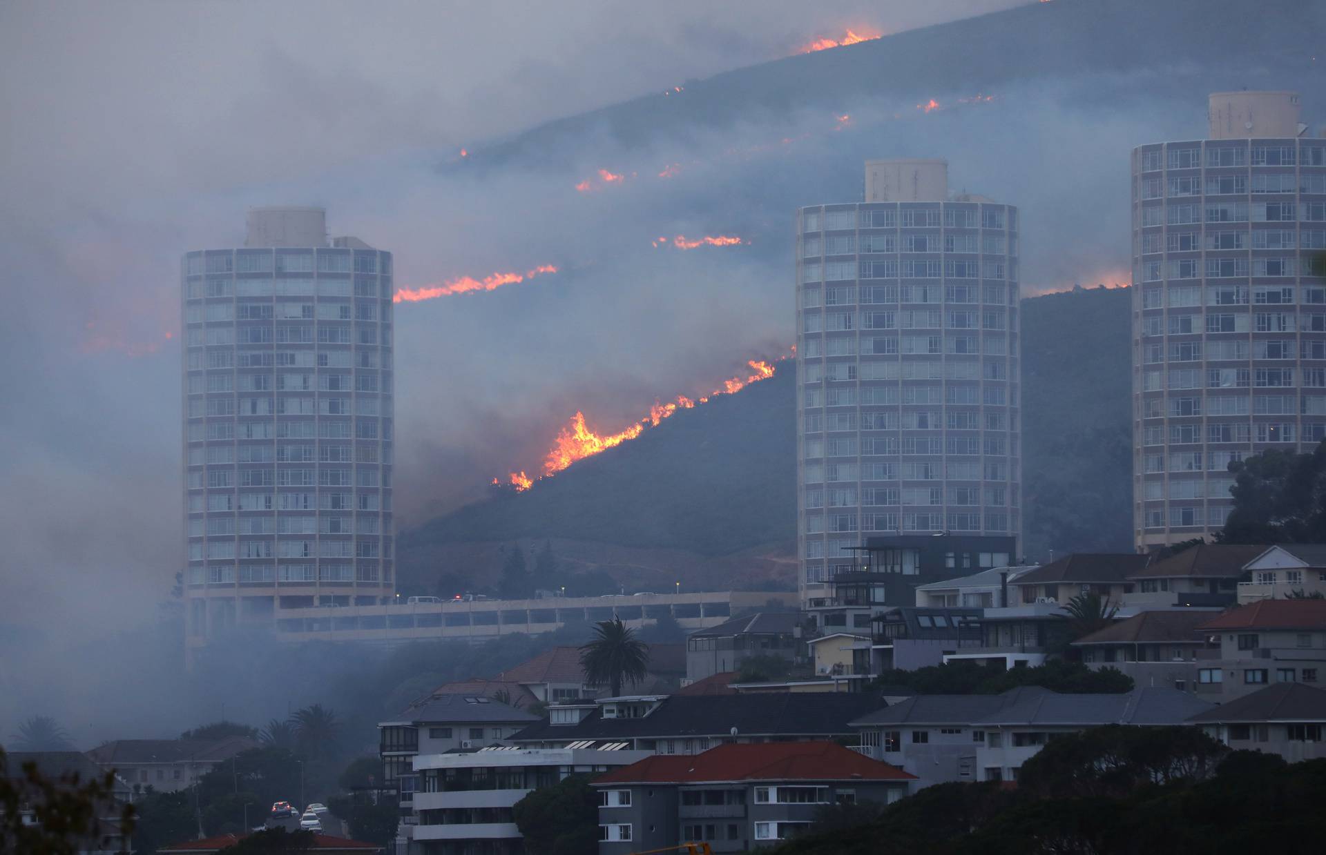 Flames are seen close to the city fanned by strong winds after  a bushfire  broke out on the slopes of Table Mountain in Cape Town