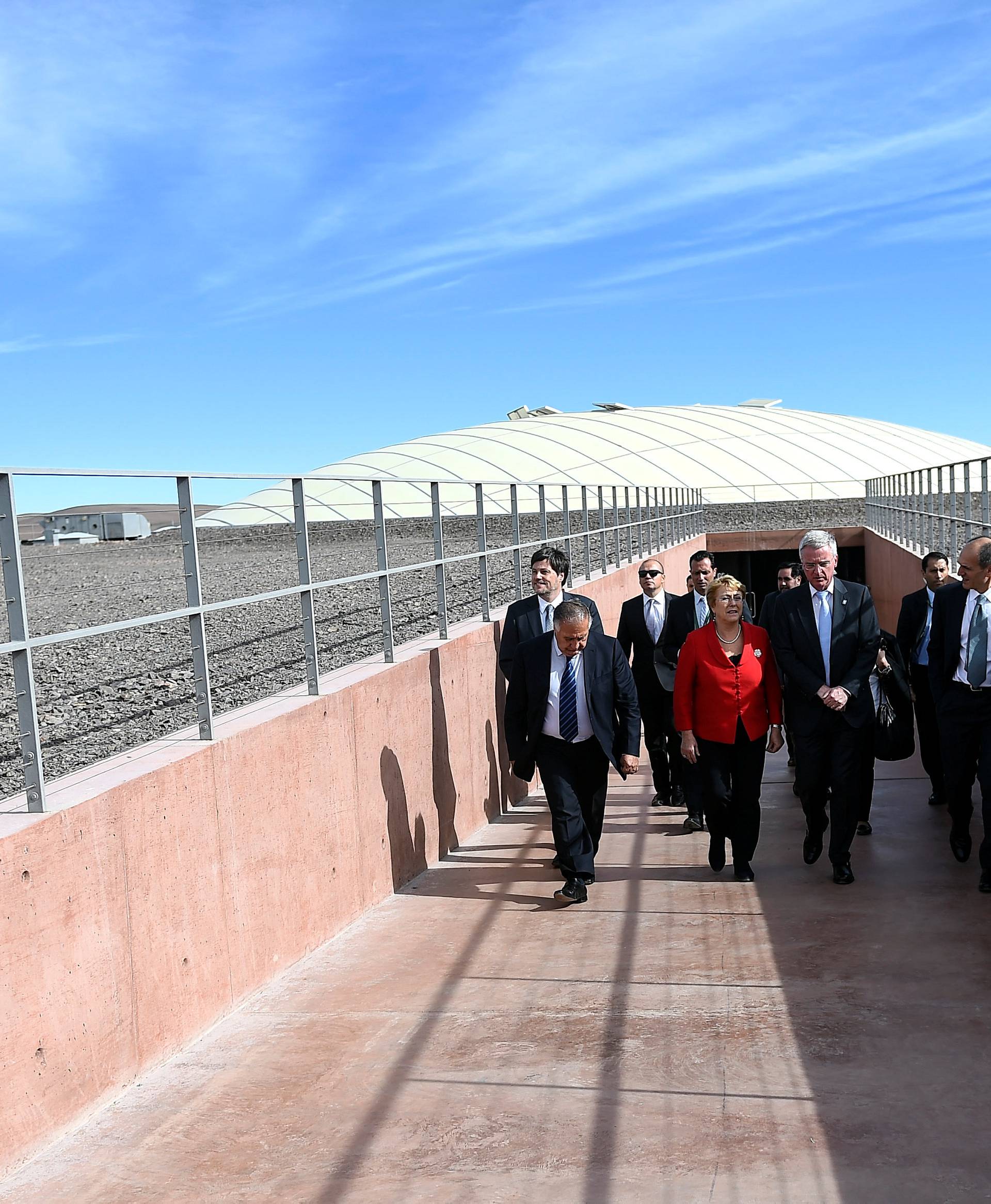 Chile's President Bachelet and Director General of the European Southern Observatory (ESO) De Zeeuw walk at the construction site of the world's largest telescope in Atacama