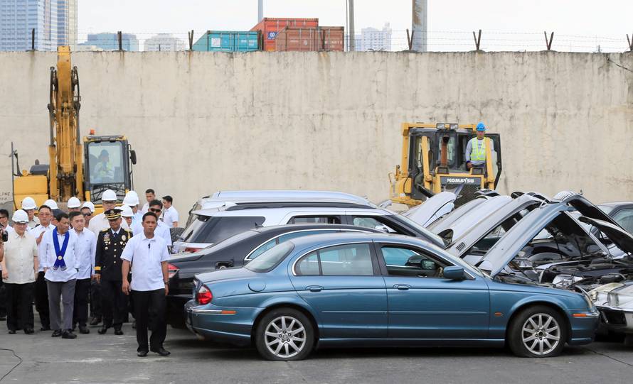 President Rodrigo Duterte inspects condemned for destruction smuggled luxury cars worth 61,626,000.00 pesos (approximately US$1.2 million), during the 116th Bureau of Customs founding anniversary in Metro Manila