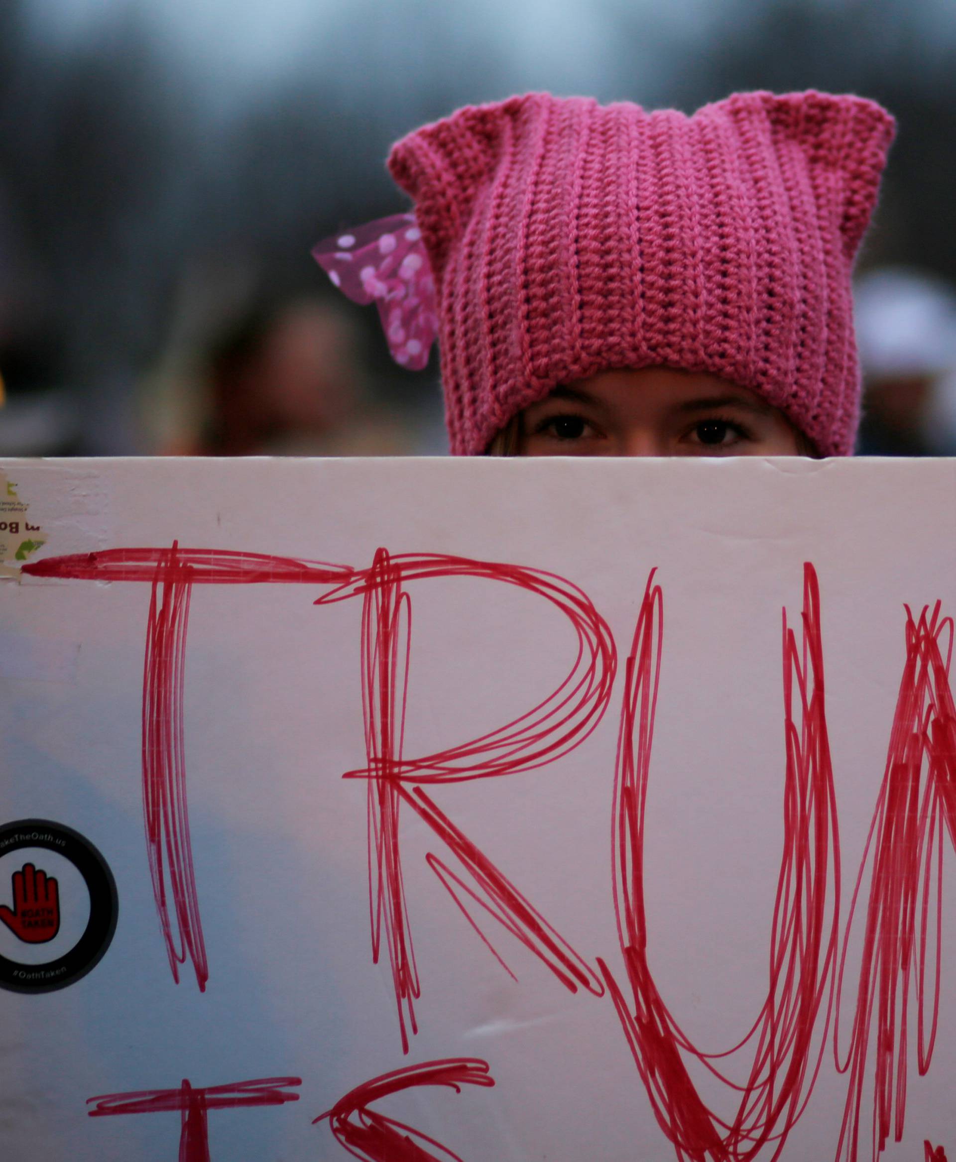 A woman wearing pink pussy protest hat poses for a photograph during the Women's March on Washington, following the inauguration of U.S. President Donald Trump, in Washington