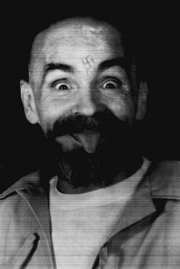 FILE PHOTO - Charles Manson clowns around as he is led to his cell