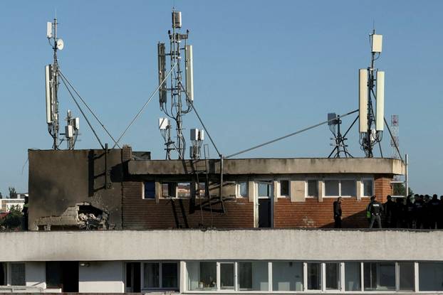 Firefighters and law enforcement work on the site of an explosion at a residential block of flats following a drone hit close to the border with Ukraine