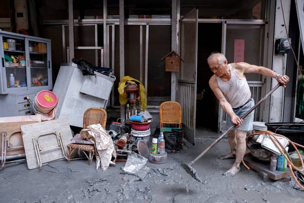 A person cleans up mud due to flooding after Super Typhoon Ragasa in Hualien