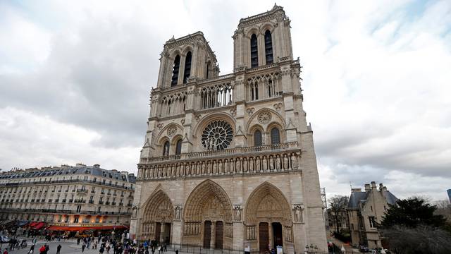 FILE PHOTO: People walk past the entrance to the Notre Dame Cathedral in Paris