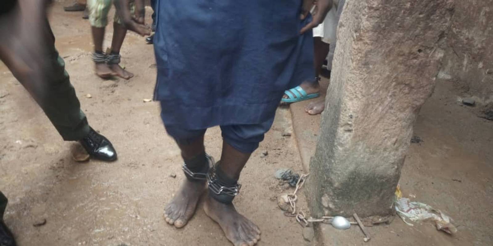 A handout picture from police shows people tied and chained after police raided a house freeing men and boys in Kaduna