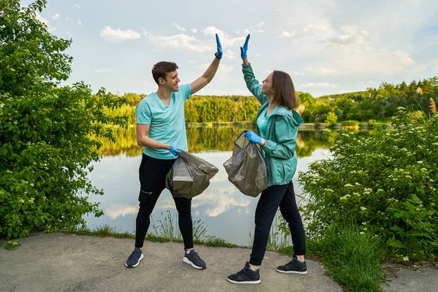 Friends,Crouching,With,Bag,Picking,Up,Trash,Doing,Plogging.plogging,Concept.