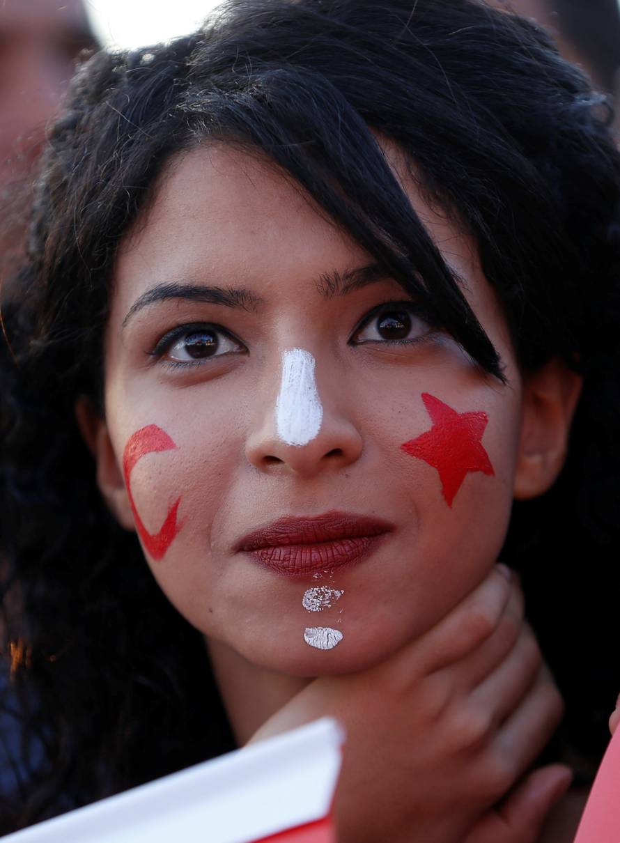 Fans react as they watch the broadcast of the FIFA World Cup Group G soccer match between Tunisia and England, in Tunis