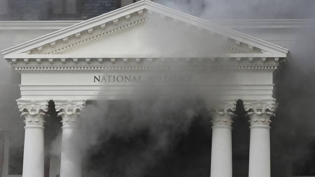 Smoke rises from the building of the Parliament in Cape Town