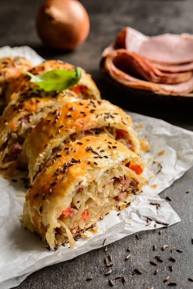 Savory strudel with sour cabbage, bacon and onion