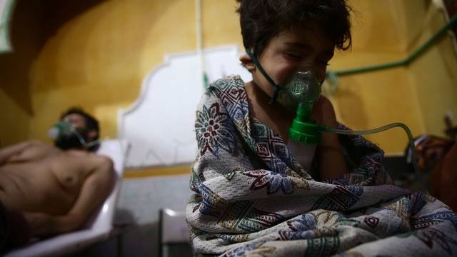 Child and man are seen in hospital in the besieged town of Douma, Eastern Ghouta, Damascus